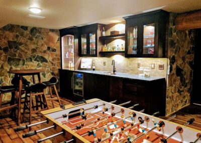 A Foosball Table in a Stylish Room with a Bar, Showcasing Modern Basement Remodeling in Menasha, WI